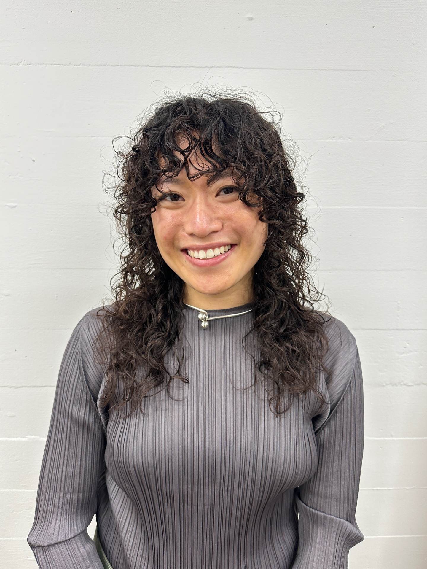 Bouncy, defined curls from a modern spiral perm.