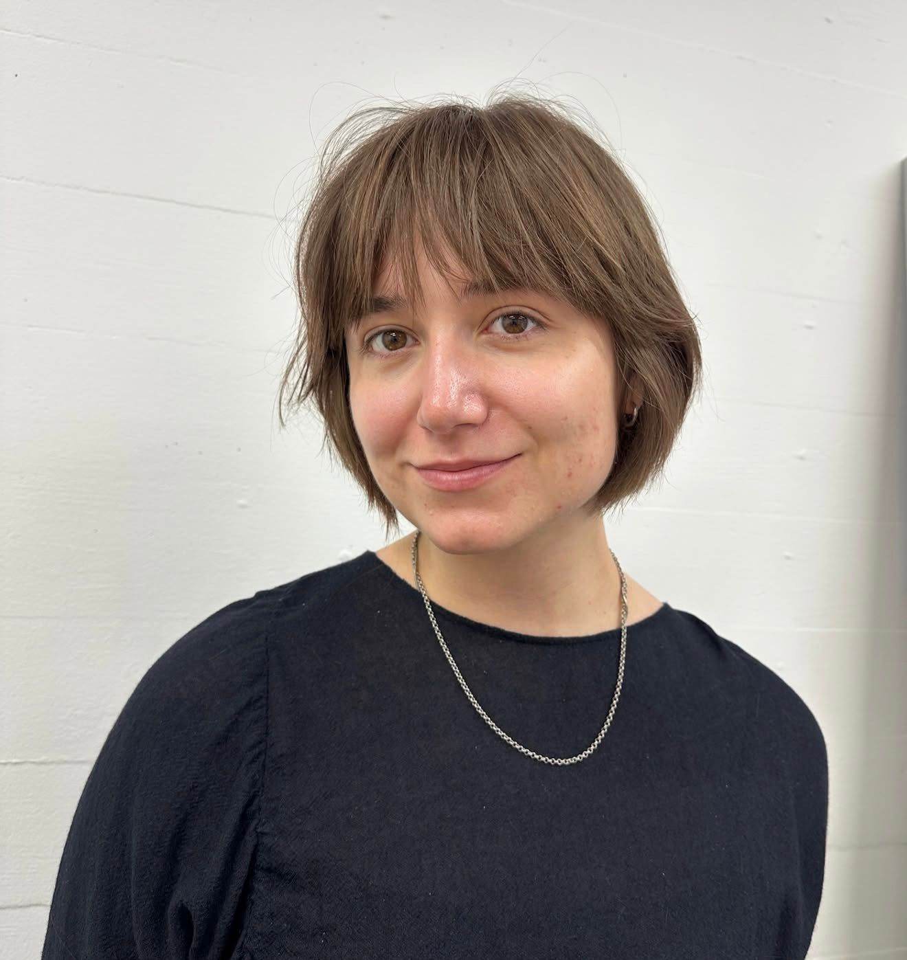 A back view of a classic bob haircut. The hair is cut to a uniform, blunt length that sits right at the jawline, creating a sleek and symmetrical look.