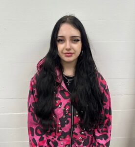 A front view of very long, dark espresso or black hair with a natural, soft wavy texture. The hair is all one length with no visible layers or defined cut, falling straight down.