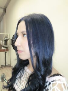 A side view of the same hair, now dyed a deep, saturated dark blue. The color is a consistent midnight navy tone from roots to ends, styled to show off the hair's natural texture and the new cool-toned hue.