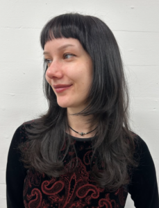 A view of long, sleek straight hair featuring several visible layers. The layers start from the mid-lengths and cascade down to the ends, adding movement and removing weight from the straight, dark hair.