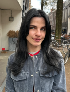 A close-up showcasing hair styled with distinct, feathered layers that create volume and movement. The ends are flicked outward to emphasize the tiered texture and flow of the cut.